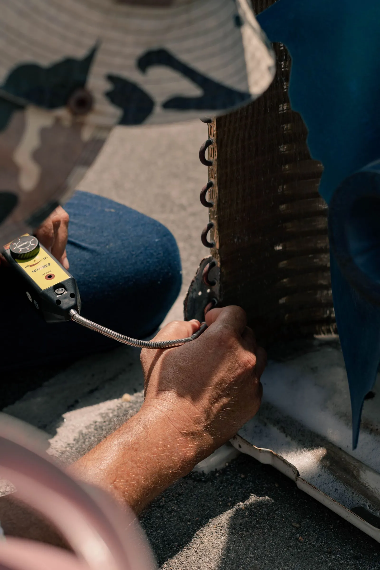 Air Conditioning Repair Cave Creek AZ — technician servicing an air conditioner with hand tools