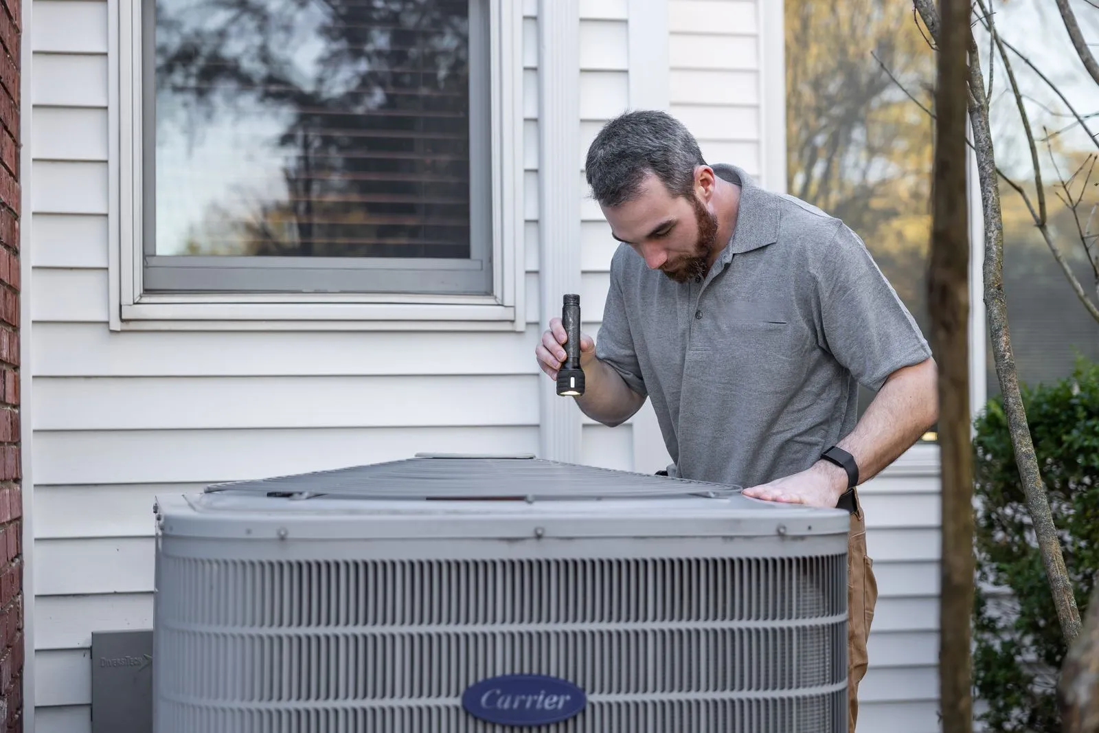 AC Repair Cave Creek AZ — technician inspecting an outdoor air conditioning unit