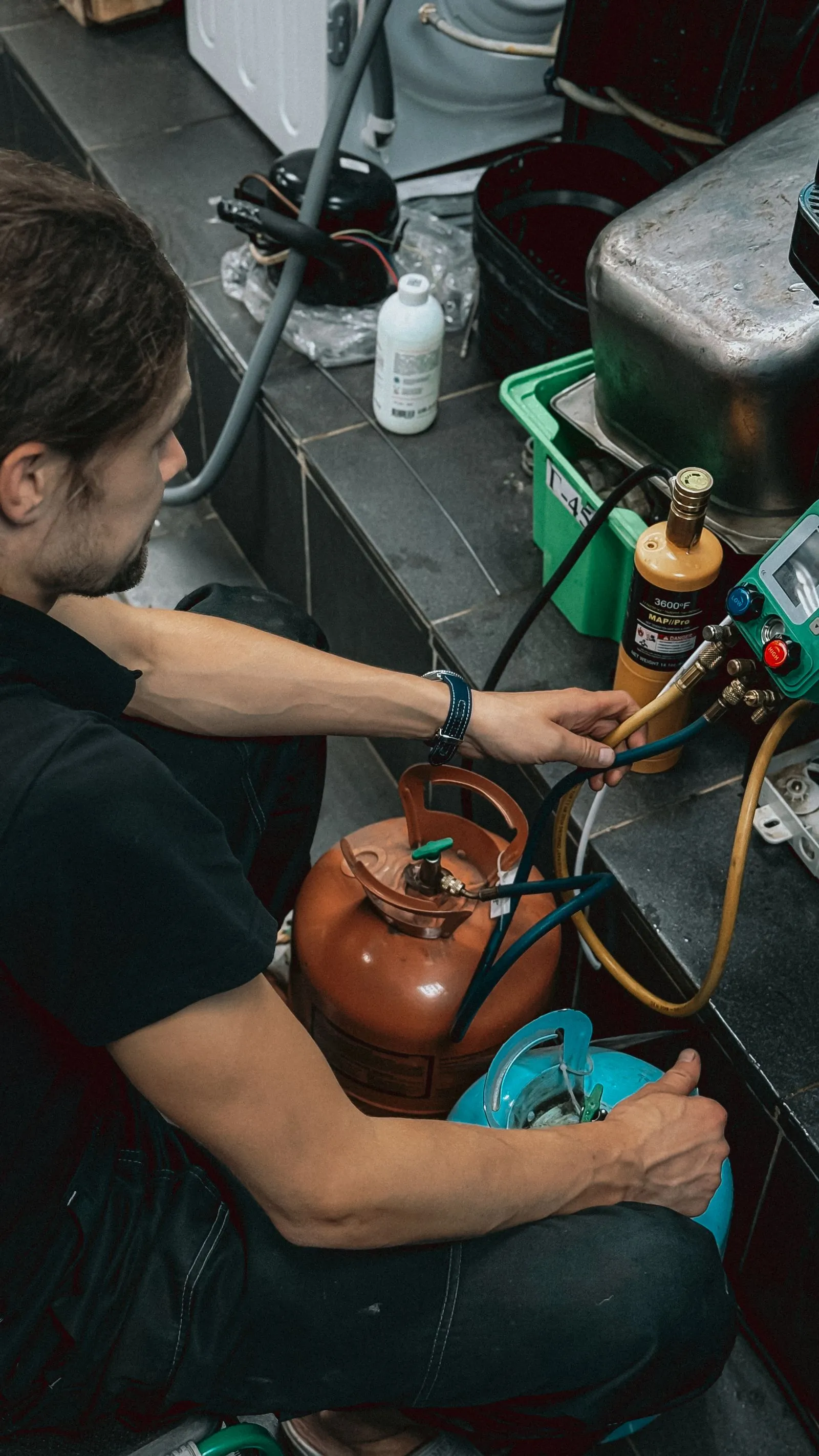 Ductwork Repair Cave Creek AZ — technician working with refrigerant gauges and service equipment